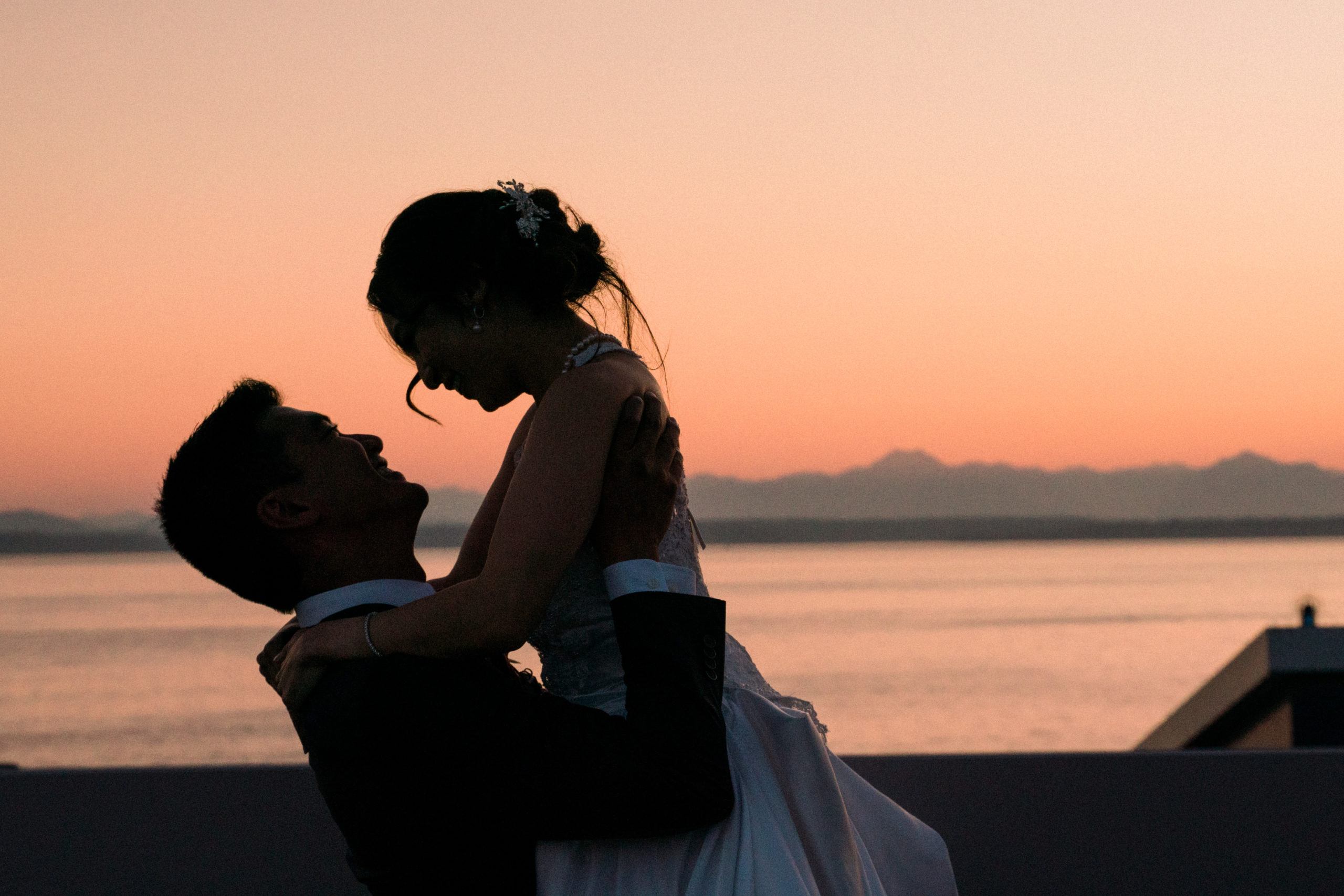 romantic couples portrait on downtown seattle skyline with waterfront views