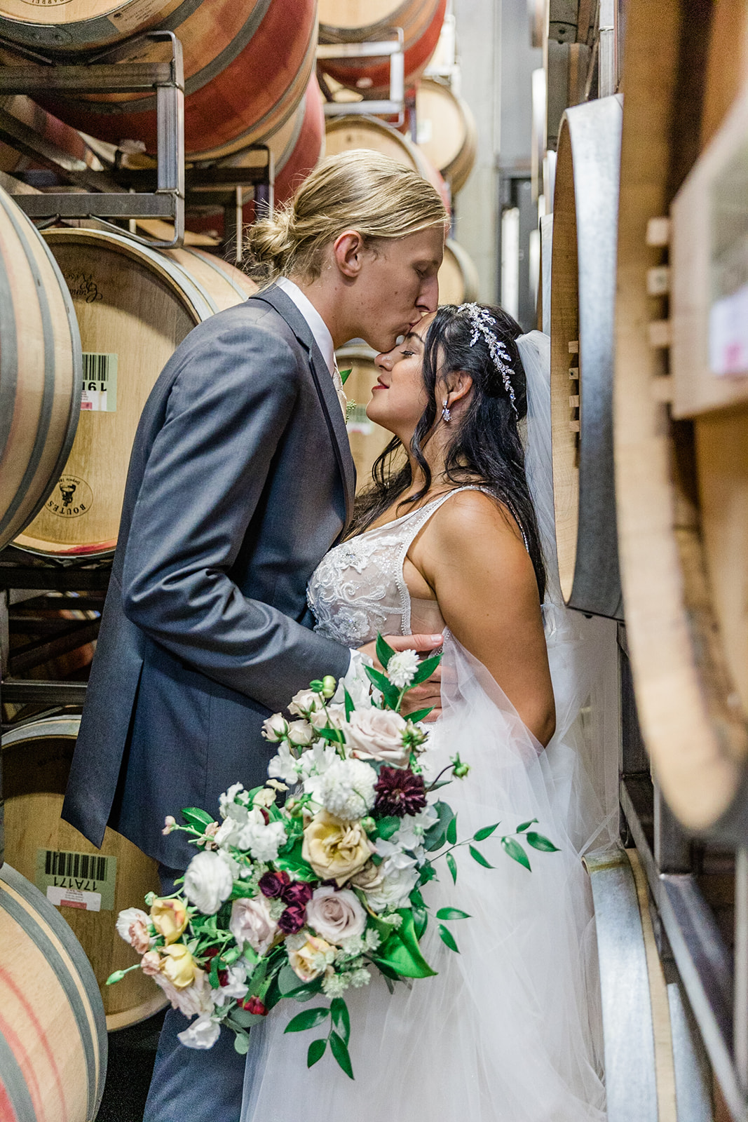 A romantic moment of the newly wedded couple in novelty hill wine barrel room