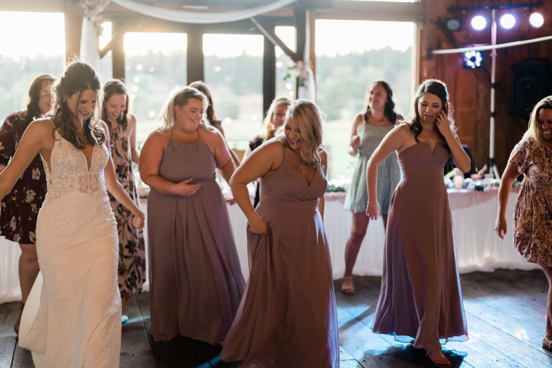 Bride and Bridesmaids dancing at a Cattle Barn Wedding