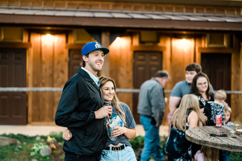 Young couple on baseball hat at a Cattle Barn Wedding