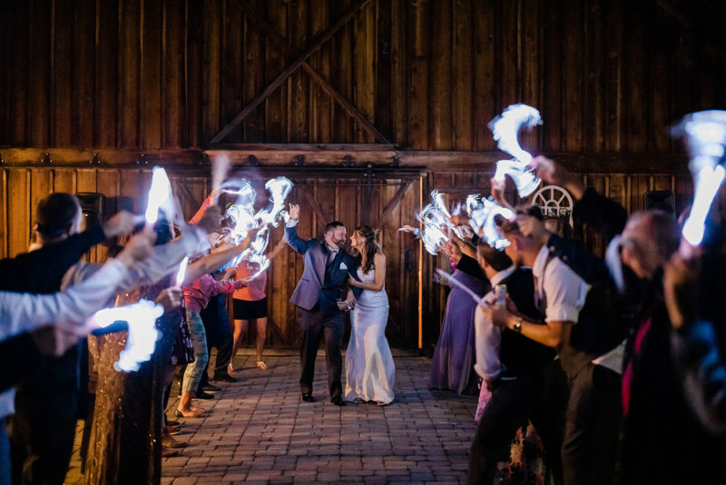 Bride and Groom leaving their Cattle Barn Wedding