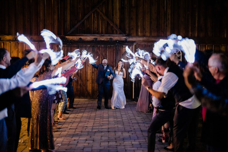 Couple walking down the isle at a Cattle Barn Wedding