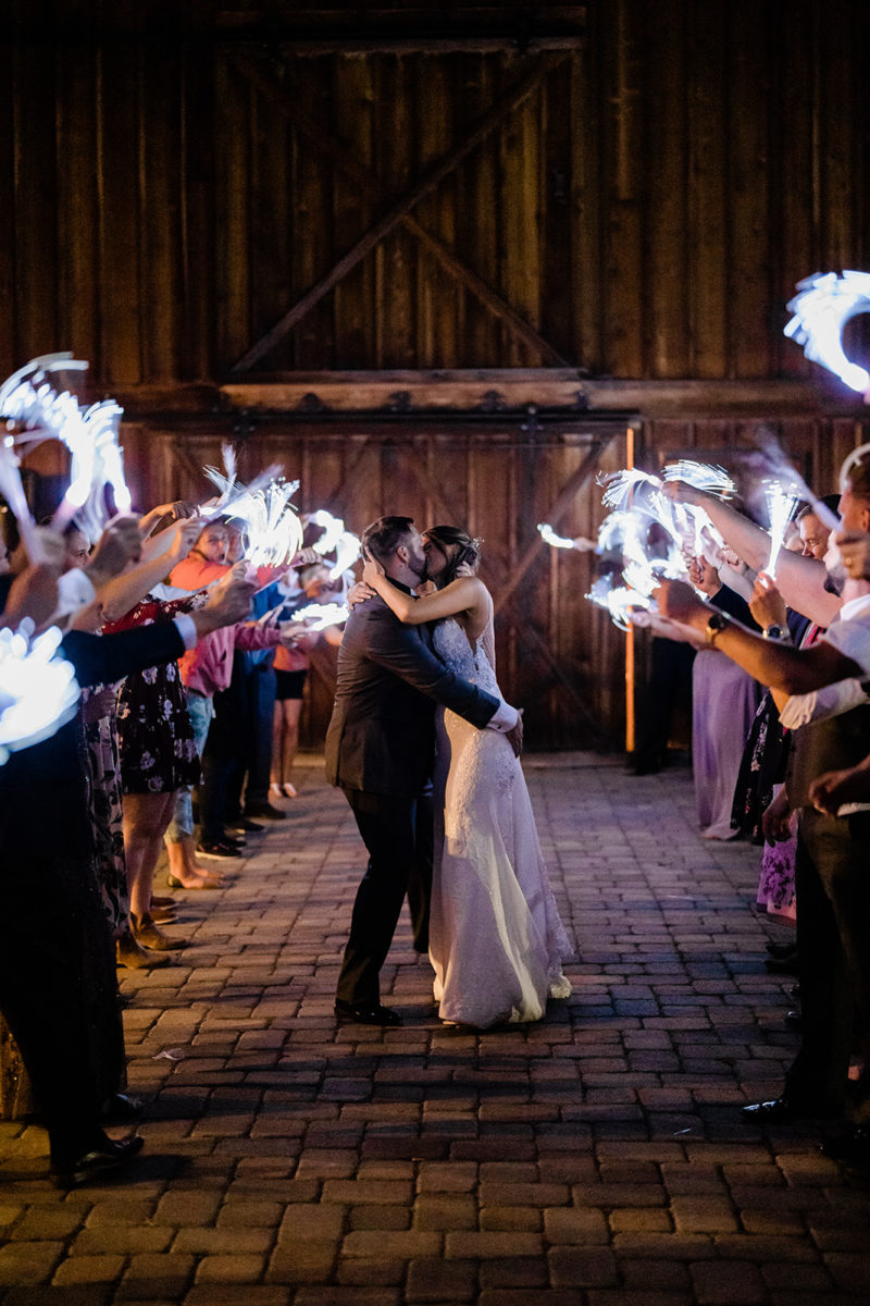 Couple walking down the isle at a Cattle Barn Wedding