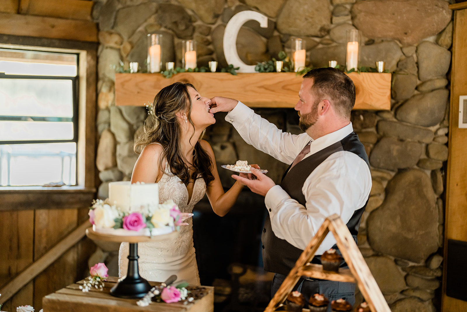 Couple feeding themselves at a Cattle Barn Wedding