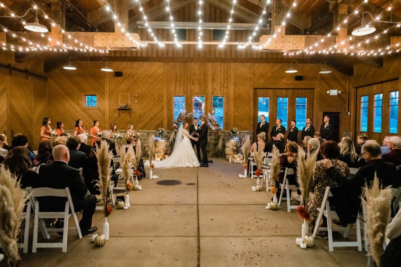 Beautiful bride and groom holding hands inside Swiftwater Cellars