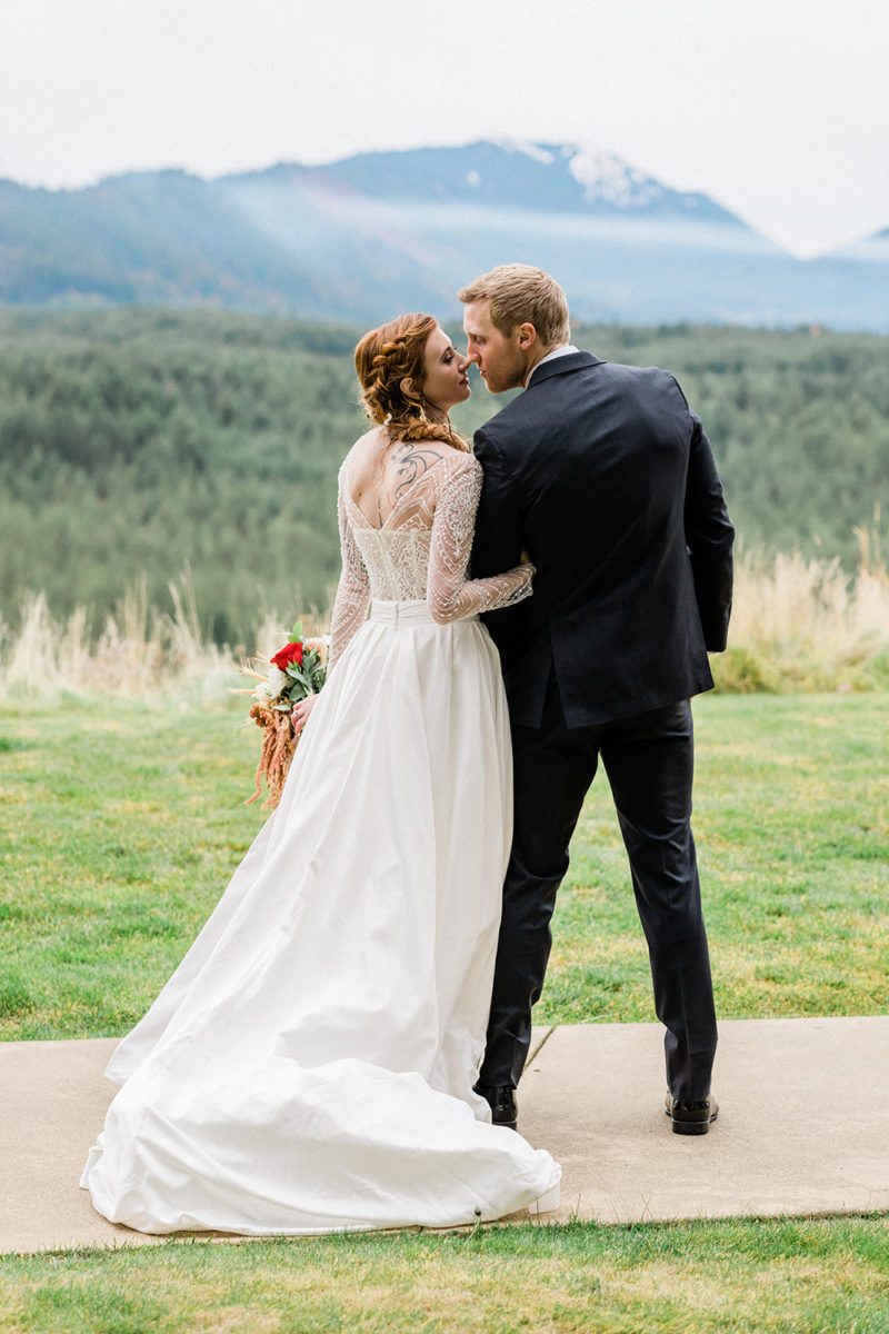 Bride and groom kiss outside at Swiftwater Cellars