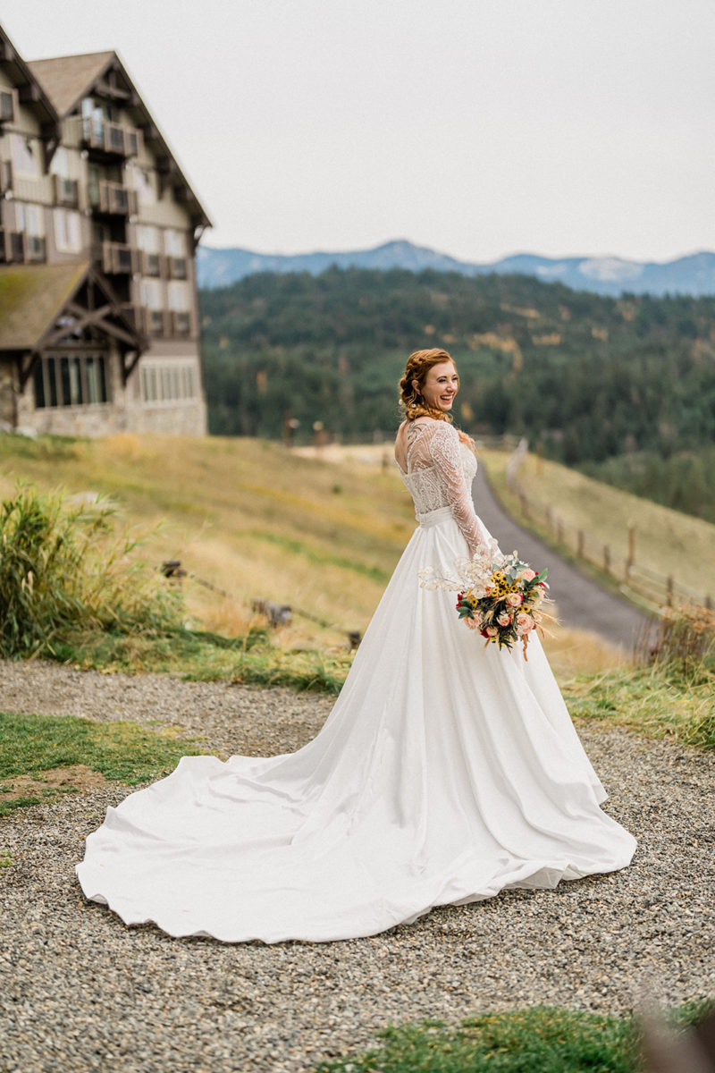 Bride smiling with mountains in background at Swiftwater Cellars