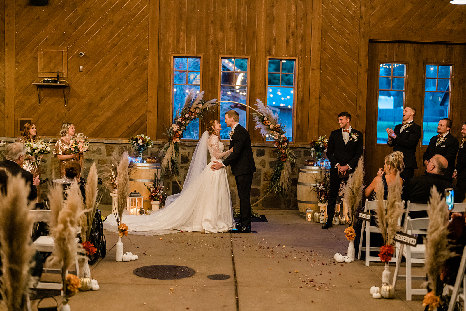 Beautiful bride and groom holding hands with windows inside Swiftwater Cellars