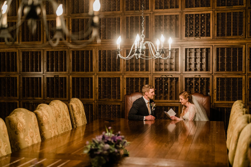 Bride and groom share a reading inside Swiftwater Cellars