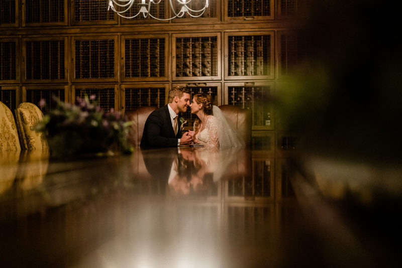 Bride and groom share a kiss inside Swiftwater Cellars