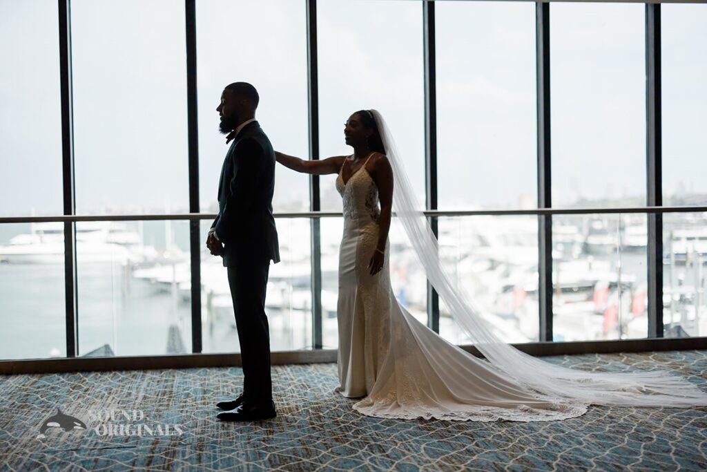 Bride taps groom&#039;s shoulder at Briza on the Bay Wedding