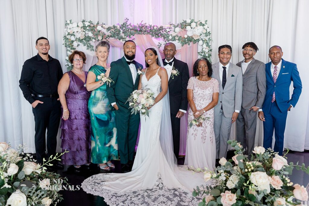 Newlyweds pose with their immediate family at Briza on the Bay Wedding