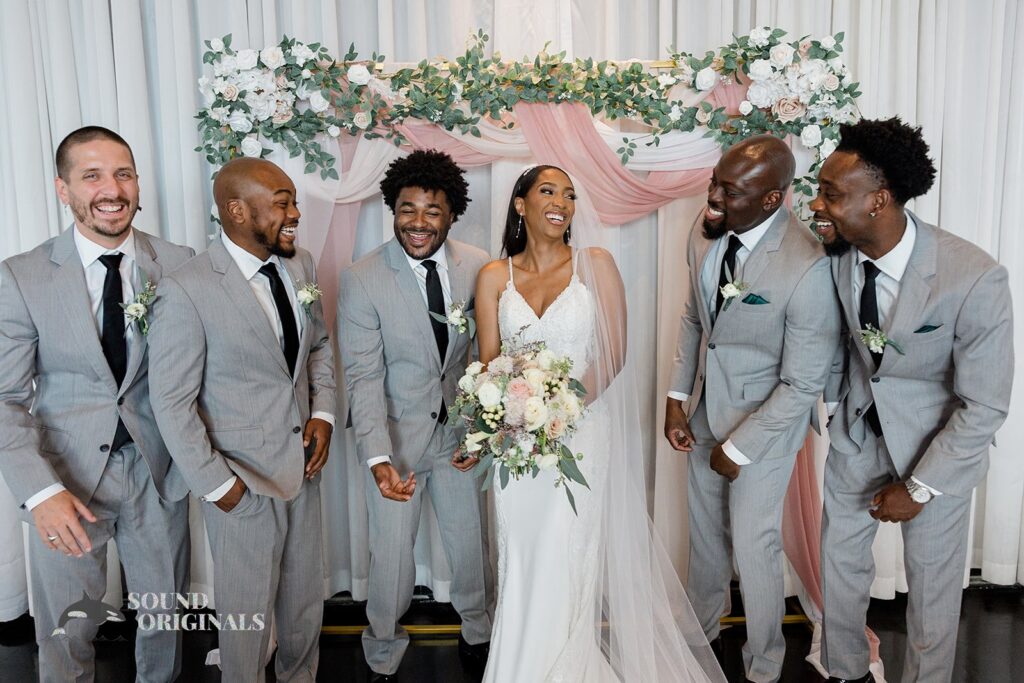 Bride being goofy with groomsmen at Briza on the Bay Wedding