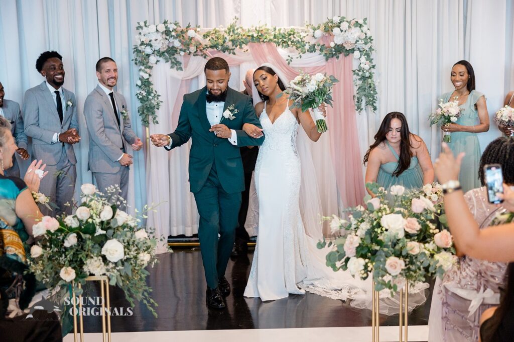 Newlyweds amusingly struts on the aisle at Briza on the Bay Wedding