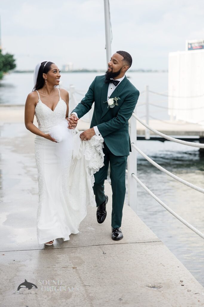 Newlyweds walk near the bay at Briza on the Bay Wedding