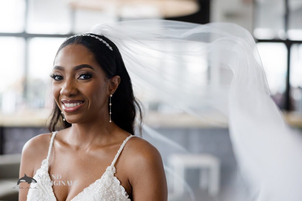 Bride with her veil blown elegantly by the wind at Briza on the Bay Wedding