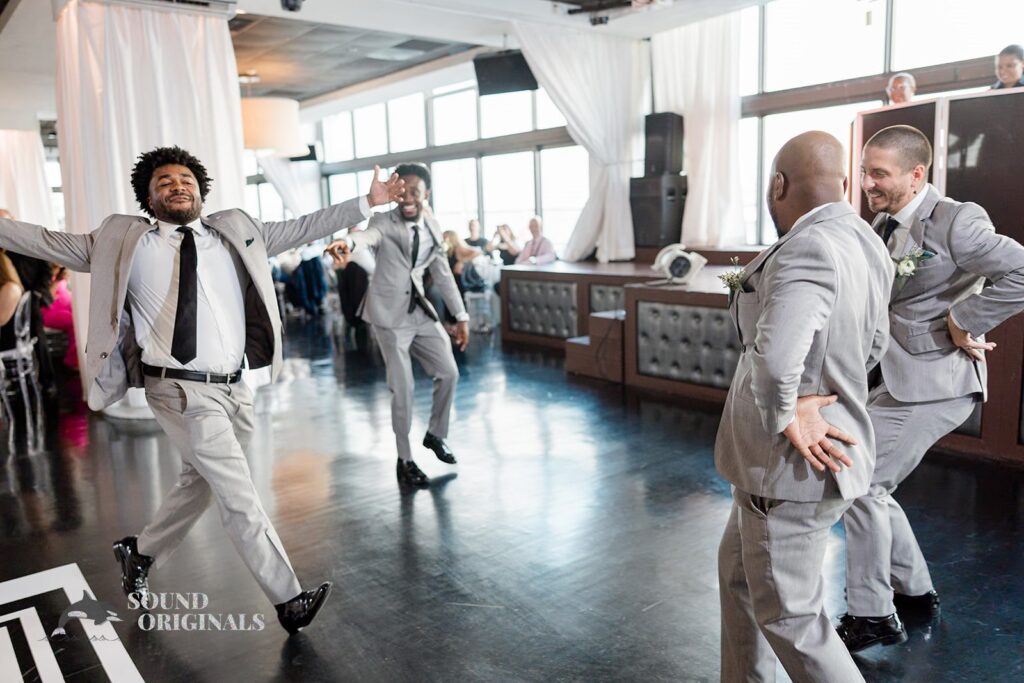 Groomsmen dance playfully at Briza on the Bay Wedding