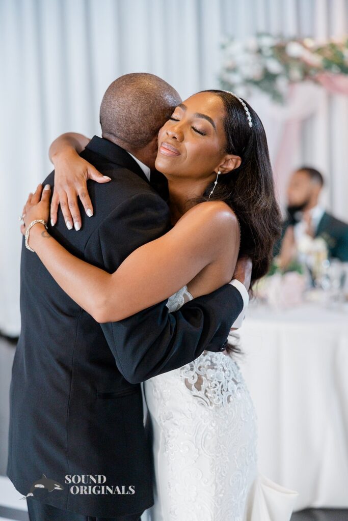 Bride tightly embraces her father at Briza on the Bay Wedding