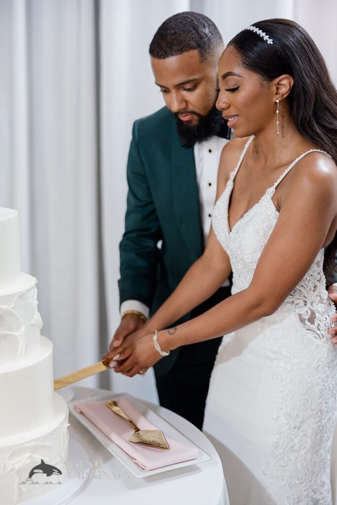 Gorgeous newlyweds cutting their wedding cake at Briza on the Bay Wedding