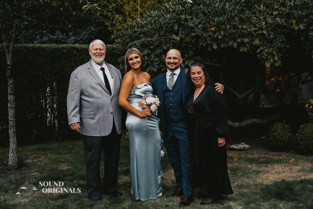 Groom with parents and sister at The Carey Gardens