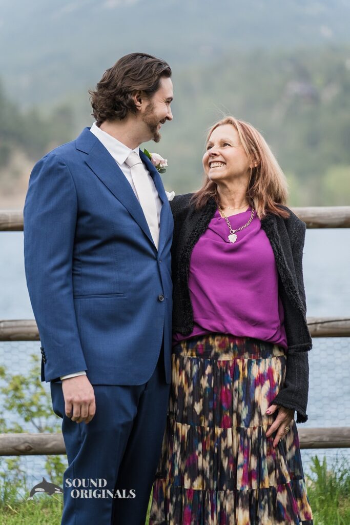 Happy Evergreen Lake House Wedding groom with Mum beside the venue&#039;s lake