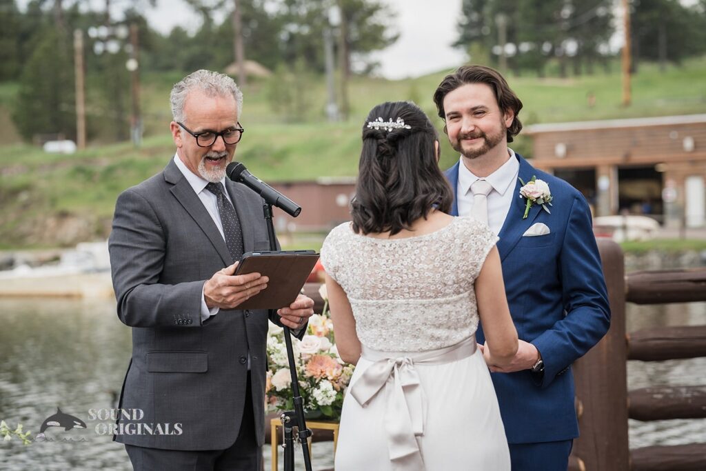 Bride and groom exchange marital vows in Evergreen Lake House Wedding