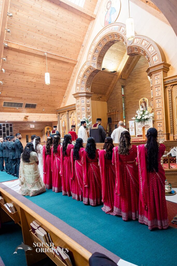 The bridal party, bride and groom standing in a line at the altar of Embassy Suites by Hilton Naperville Wedding