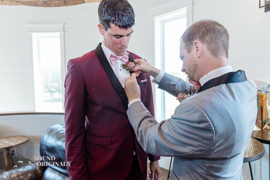 Groom&#039;s man gets groom ready for The French Farmhouse Wedding