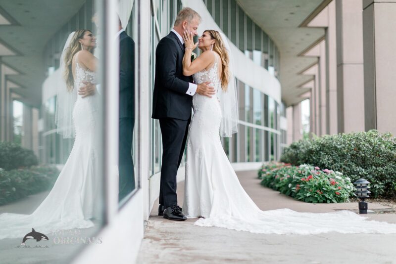 Wife touches her husband's face and looks at him happily after the Harborside Chapel Wedding