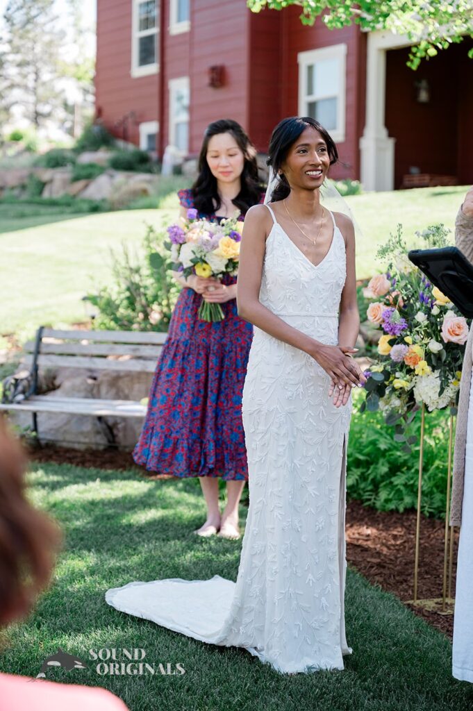 The bride and bridesmaid standing at the altar of The Red Farmhouse Bed & Breakfast Wedding