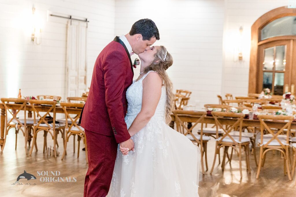 Bride and groom take a romantic kiss in The French Farmhouse Wedding