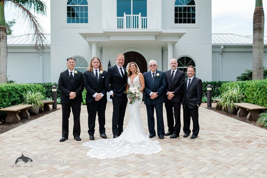 Newlyweds with groom's Harborside Chapel Wedding entourage